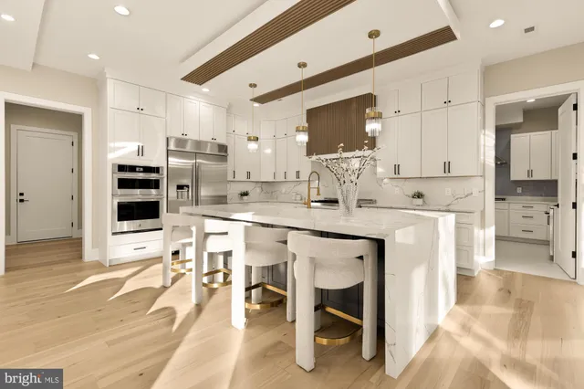 a kitchen with granite countertop white cabinets and white appliances