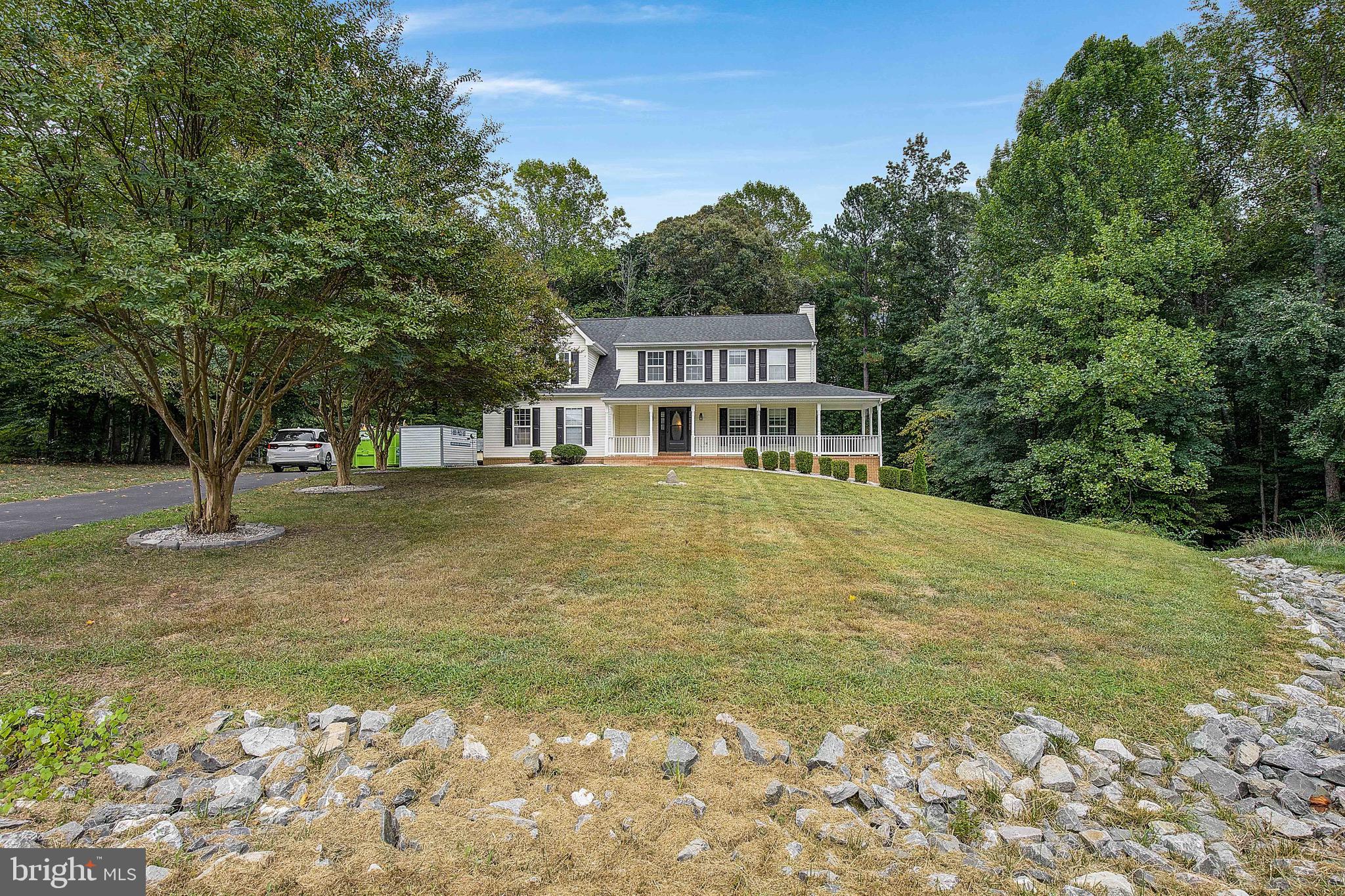 721 Small Reward Road Huntingtown, MD 20639 - Photo 51 of 51 a house with trees in front of it