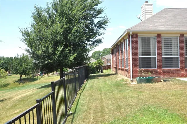 a view of house with backyard and outdoor seating