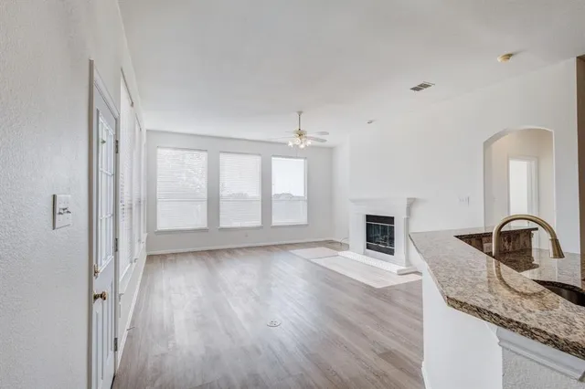 a view of a kitchen with a sink dishwasher and a fireplace