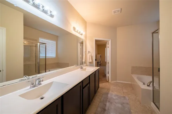 a bathroom with a double vanity sink a toilet and a mirror