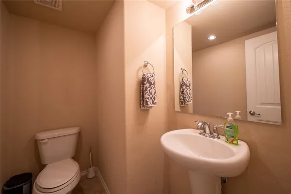 a bathroom with a sink a toilet and mirror