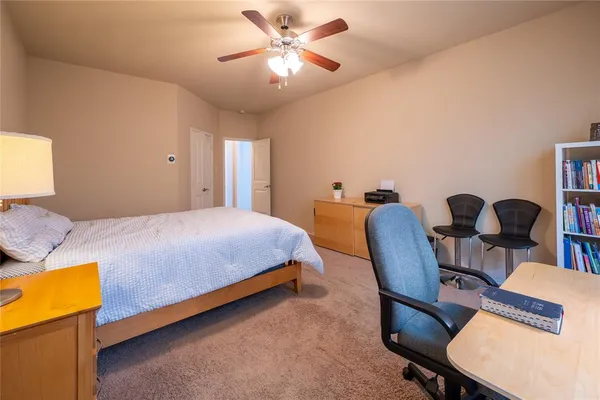 a bedroom with a bed a desk and chair