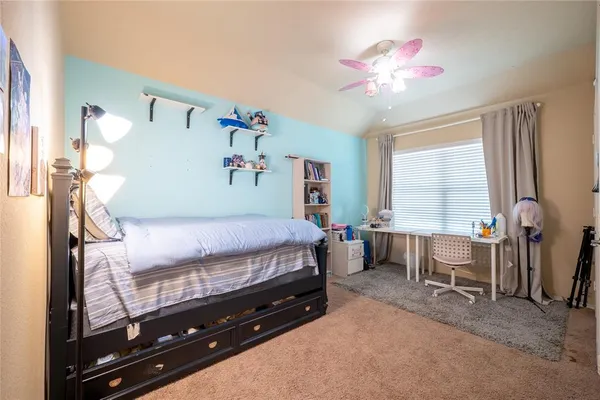 a bed room with a bed and a chandelier