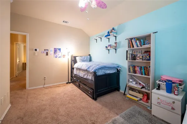 a bed room with a bed and a book shelf
