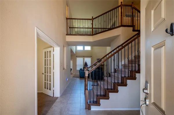 a view of entryway with wooden floor and stairs