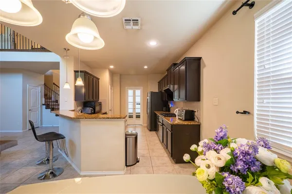 a kitchen with stainless steel appliances kitchen island granite countertop a sink and cabinets