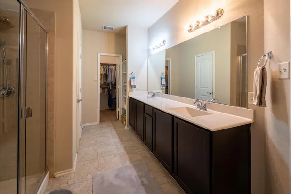 a bathroom with a double vanity sink and a mirror