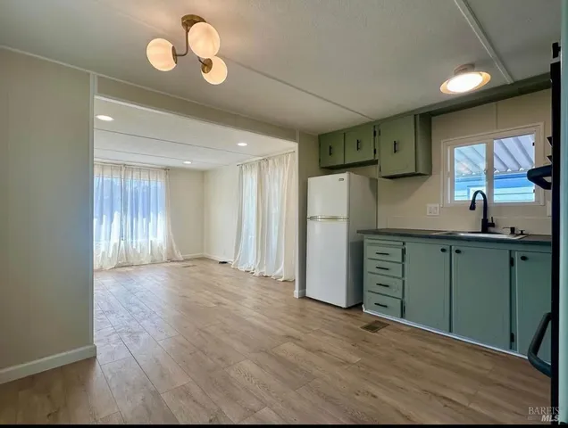 a kitchen with stainless steel appliances granite countertop a refrigerator and a sink