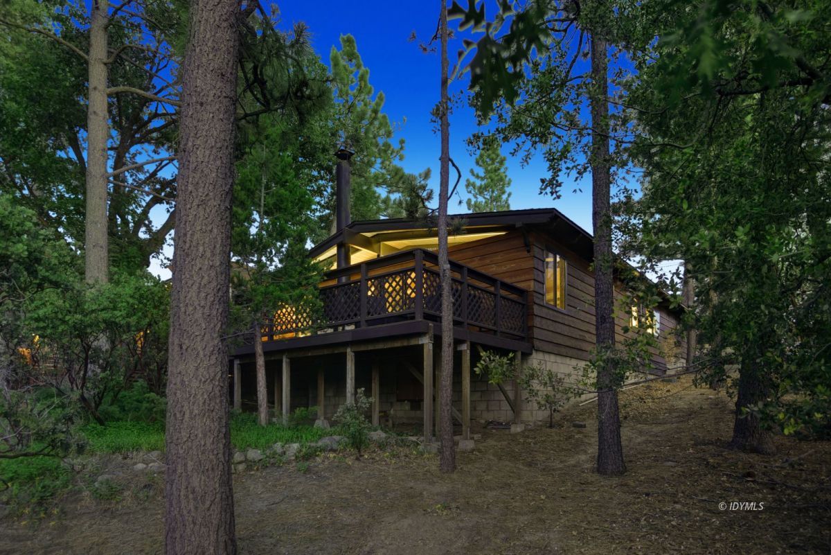 26780 Saunders Meadow Road Idyllwild, CA 92549 - Photo 2 of 41 a view of a wooden house with a yard