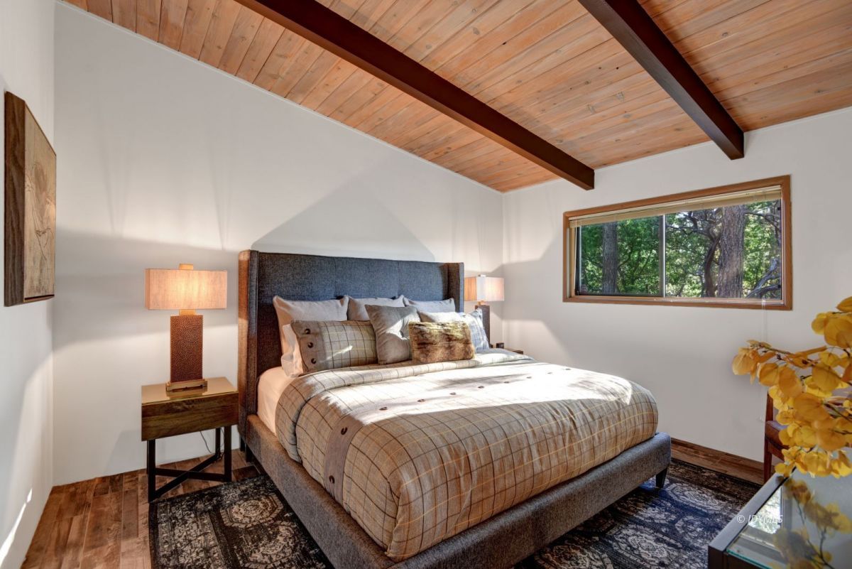 26780 Saunders Meadow Road Idyllwild, CA 92549 - Photo 33 of 41 a bedroom with a bed a lamp and a large window