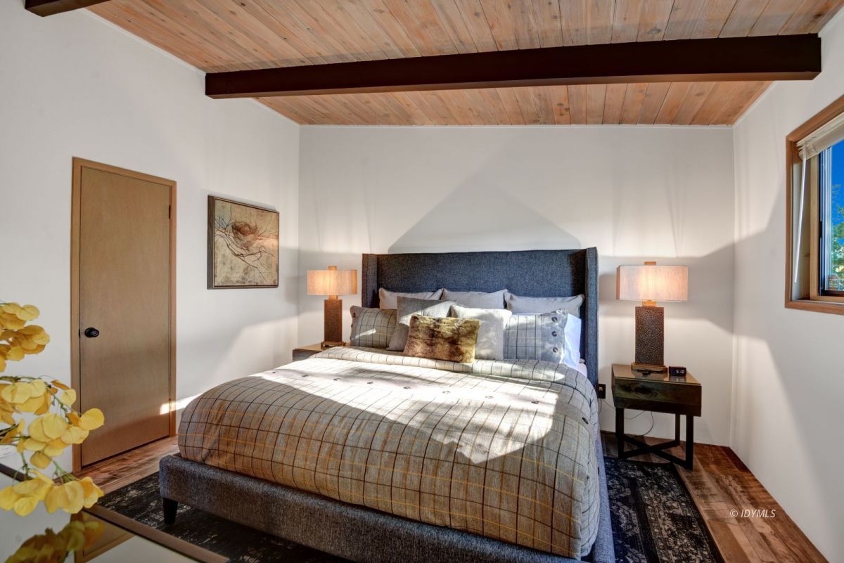 26780 Saunders Meadow Road Idyllwild, CA 92549 - Photo 34 of 41 a bedroom with a bed and wooden floor