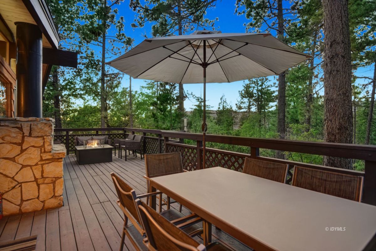 26780 Saunders Meadow Road Idyllwild, CA 92549 - Photo 6 of 41 a view of a couches in the deck under a umbrella
