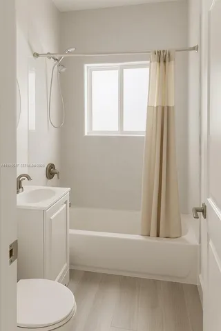 a bathroom with a sink a mirror a toilet and shower