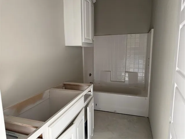 a bathroom with a bathtub sink and vanity