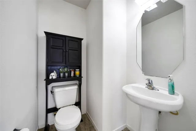 a white toilet sitting next to a bathroom sink