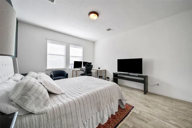 a bedroom with a bed and a flat screen tv