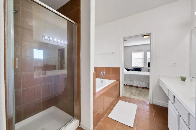 a bathroom with a tub sink and mirror
