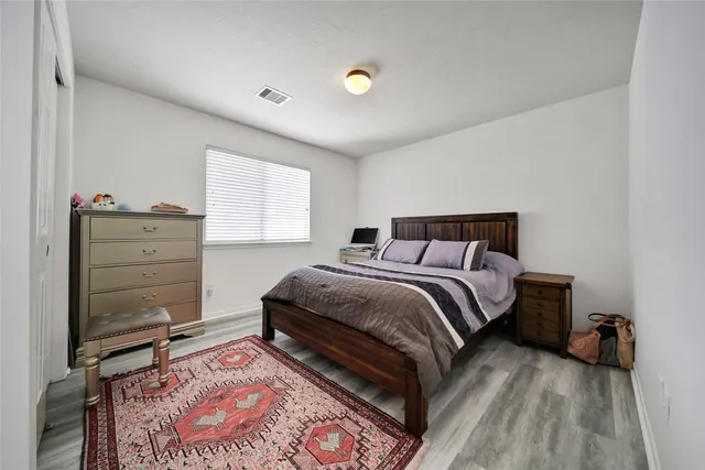 a bedroom with a bed and cabinets