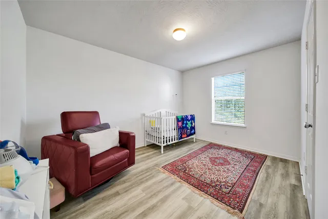 a bedroom with furniture and a wooden floor