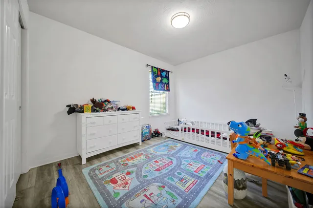 a bed room with bed and two windows