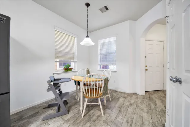 a view of a dining room with furniture window and wooden floor