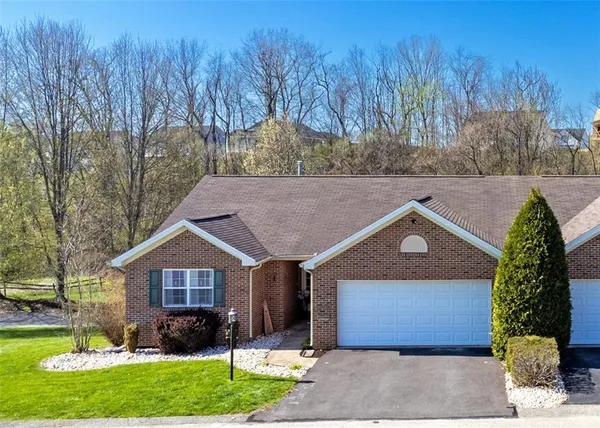 a front view of house with a garden