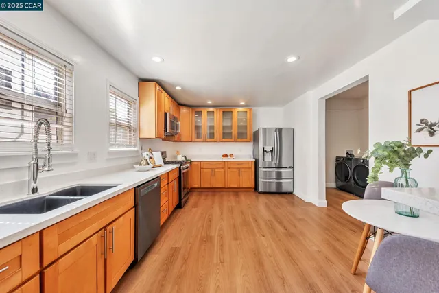 a large kitchen with stainless steel appliances lots of counter space and a sink