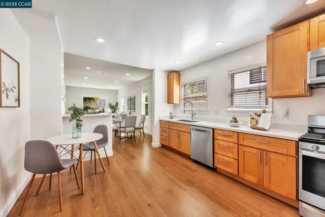 a large kitchen with a table and chairs