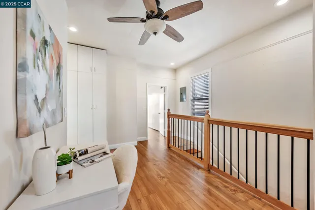 a view of a hallway with a dining table chairs