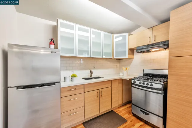 a kitchen with a refrigerator and a sink
