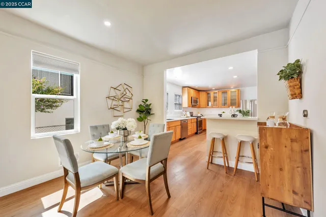 a dining room with furniture and wooden floor