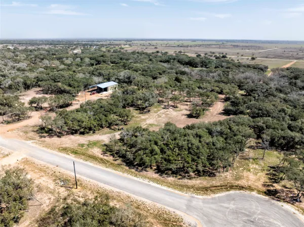 an aerial view of a houses with a yard