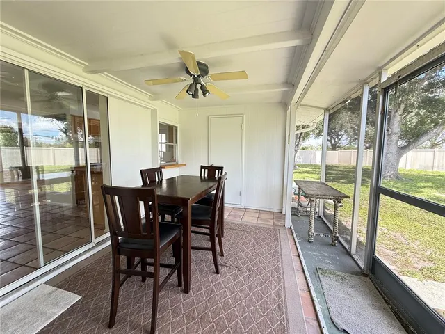 a view of a dining room with furniture and a potted plant