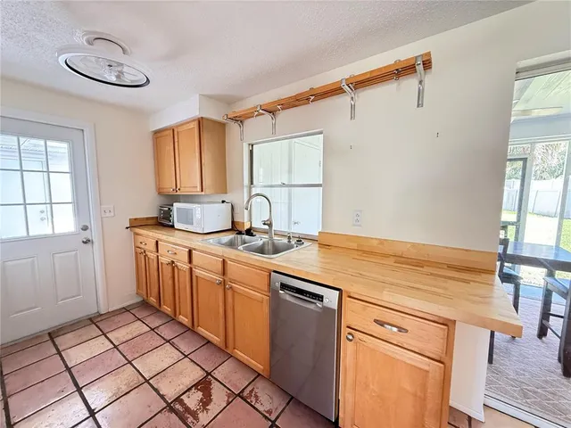 a kitchen with a sink cabinets and window