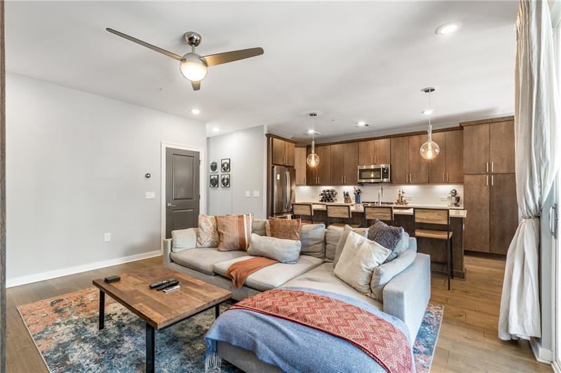 383 Pratt Drive, Unit 504 Atlanta, GA 30315 - Photo 11 of 48 a living room with furniture kitchen view and a chandelier