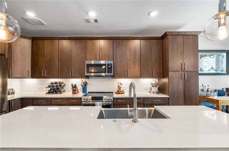 383 Pratt Drive, Unit 504 Atlanta, GA 30315 - Photo 12 of 48 a kitchen with kitchen island granite countertop a sink appliances and cabinets