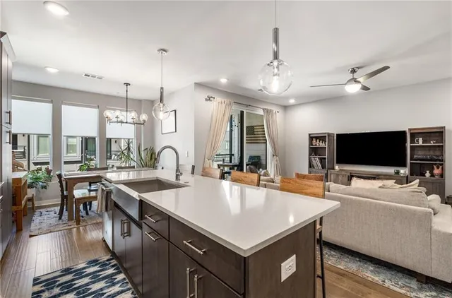 a large kitchen with kitchen island a sink appliances and a table