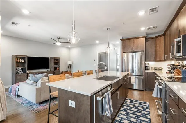 a kitchen with a stove a sink and a refrigerator