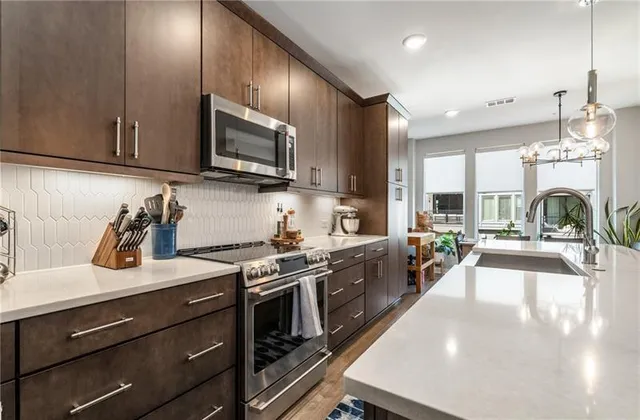 a kitchen with stove a sink and cabinets