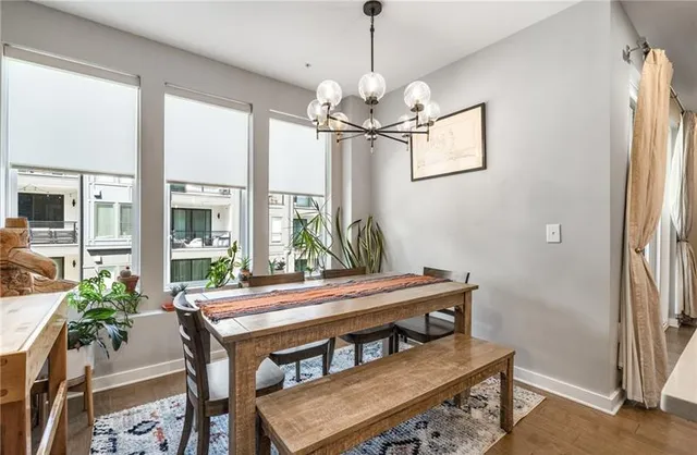 a view of a dining room with furniture window and wooden floor