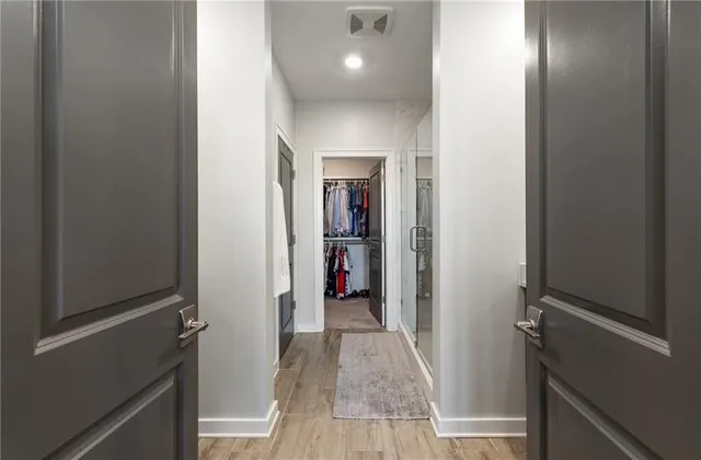 a view of a hallway with wooden shelves