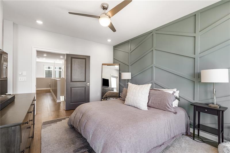 383 Pratt Drive, Unit 504 Atlanta, GA 30315 - Photo 32 of 48 a bedroom with a bed and a chandelier