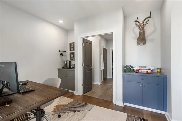 a view of a workspace with furniture and wooden floor