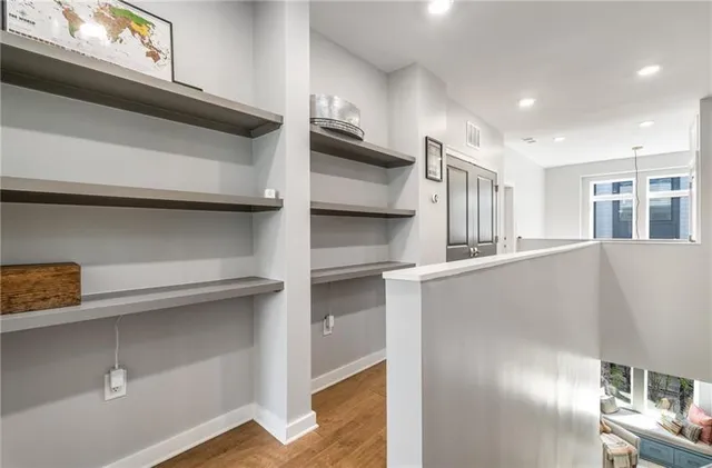 a view of walk in closet with windows