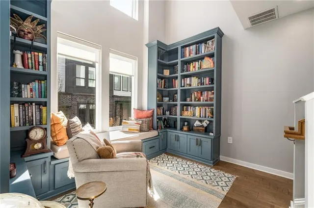 a living room with furniture a bookshelf and a book shelf