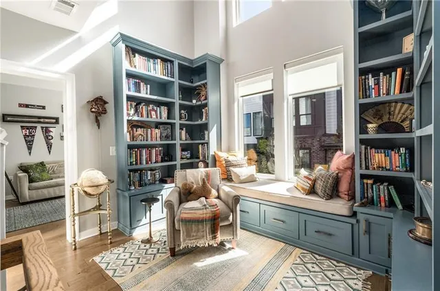 a living room with furniture and a book shelf
