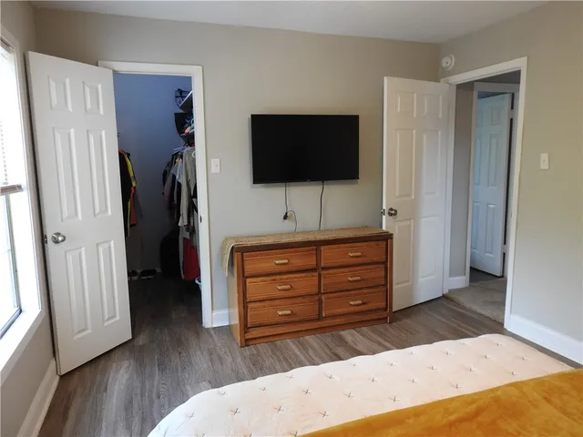 a room with a bed and a flat screen tv