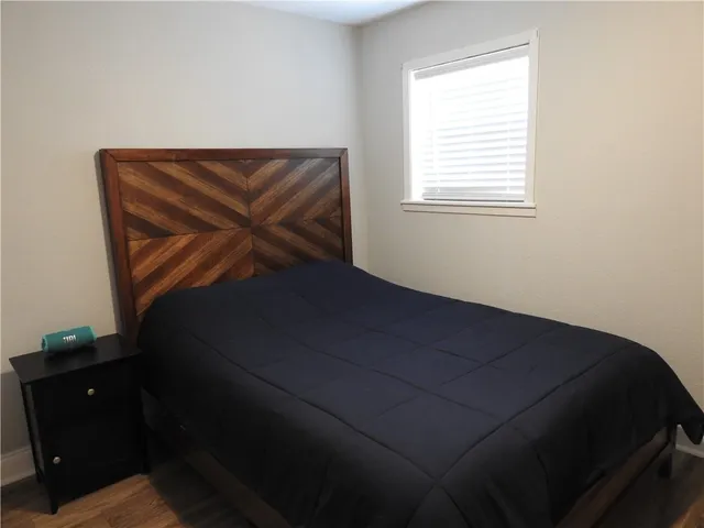 an empty room with a wooden floor and a window