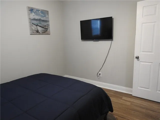 a bedroom with a bed and a flat screen tv